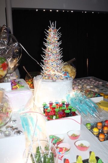 A candy and treats table under string lights
