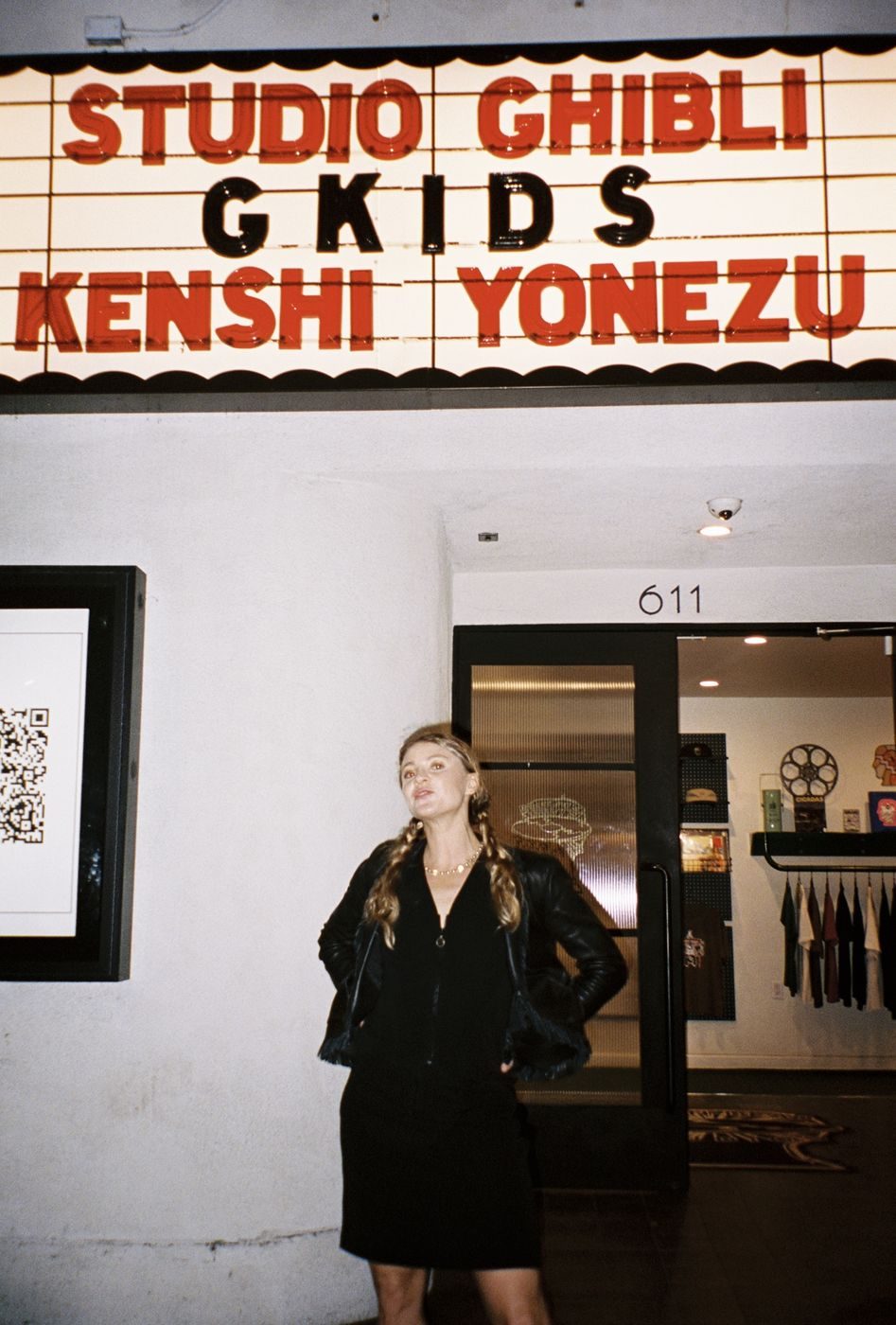 A guest beneath a marquee reading Studio Ghibli GKIDS Kenshi Yonezu